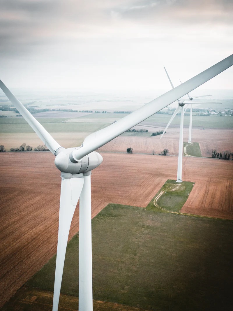 Wind turbines turning over open farmland