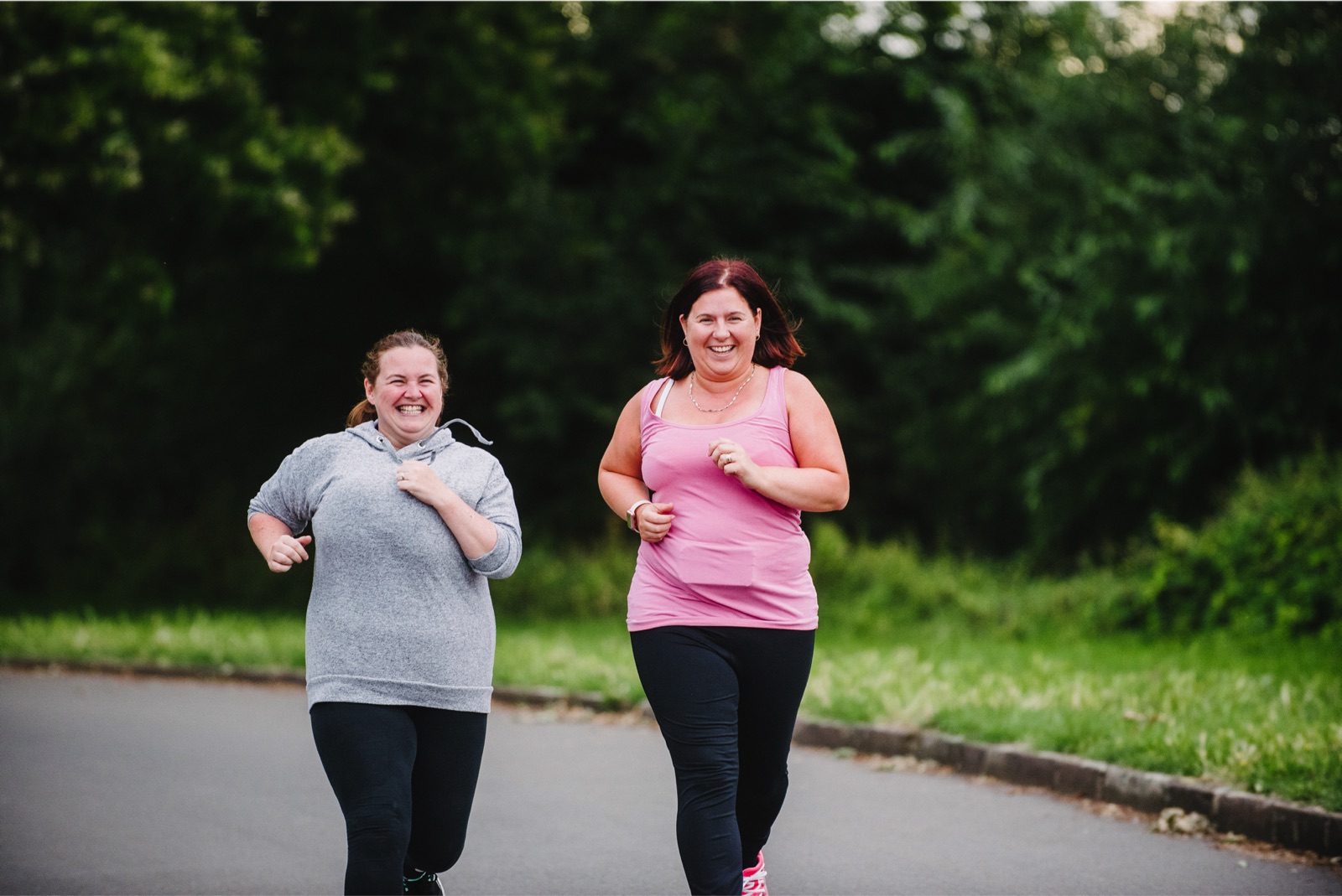 Three women jogging together on a country path